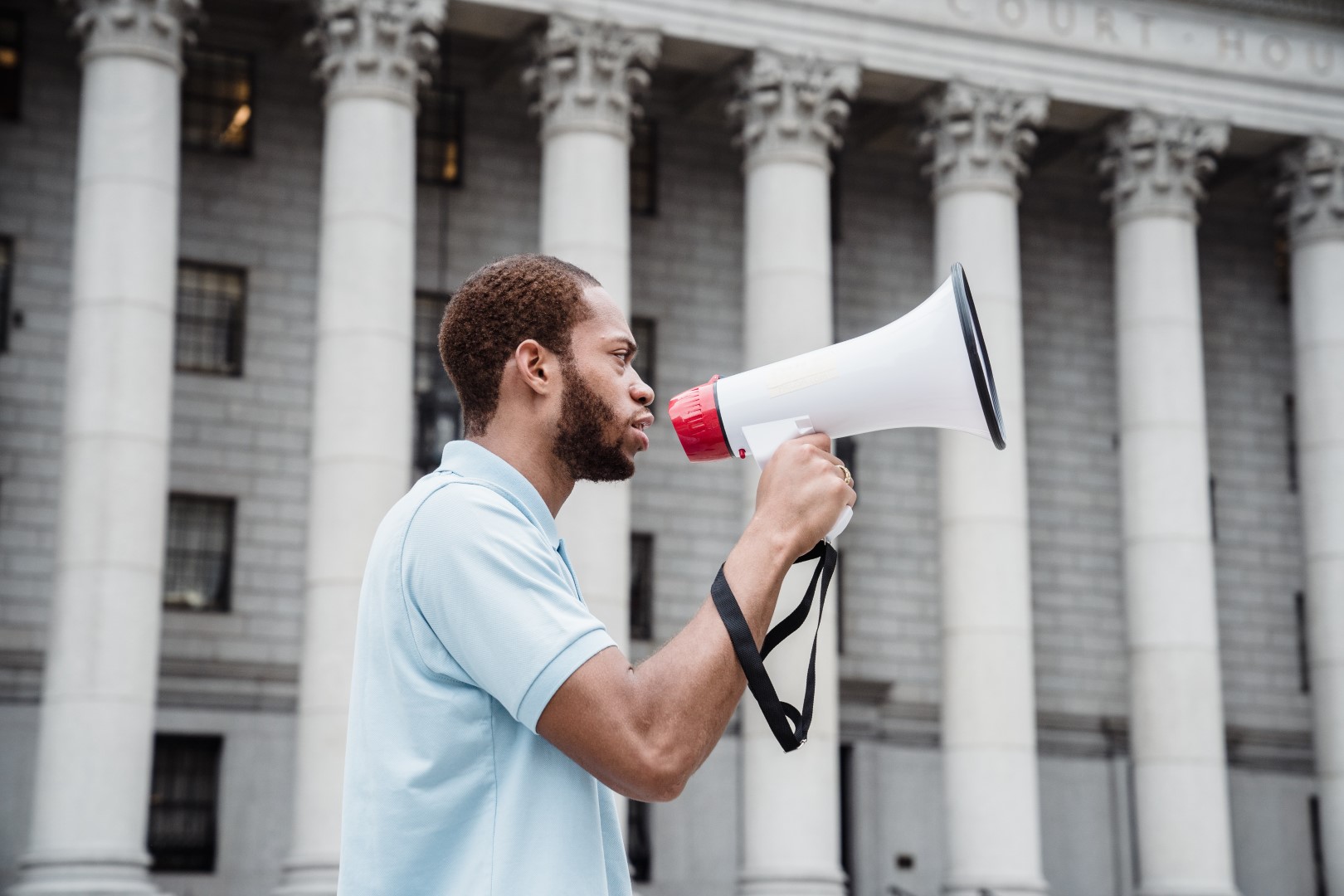 A man with a beard is holding a megaphone